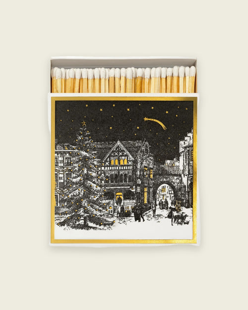Archivist Starry Night matchbox, winter village beneath a starry sky with gold foil, open to show the matches